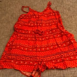 Cute orange flower print romper with spaghetti straps.